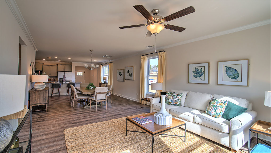 Living room beside kitchen with large windows and back door