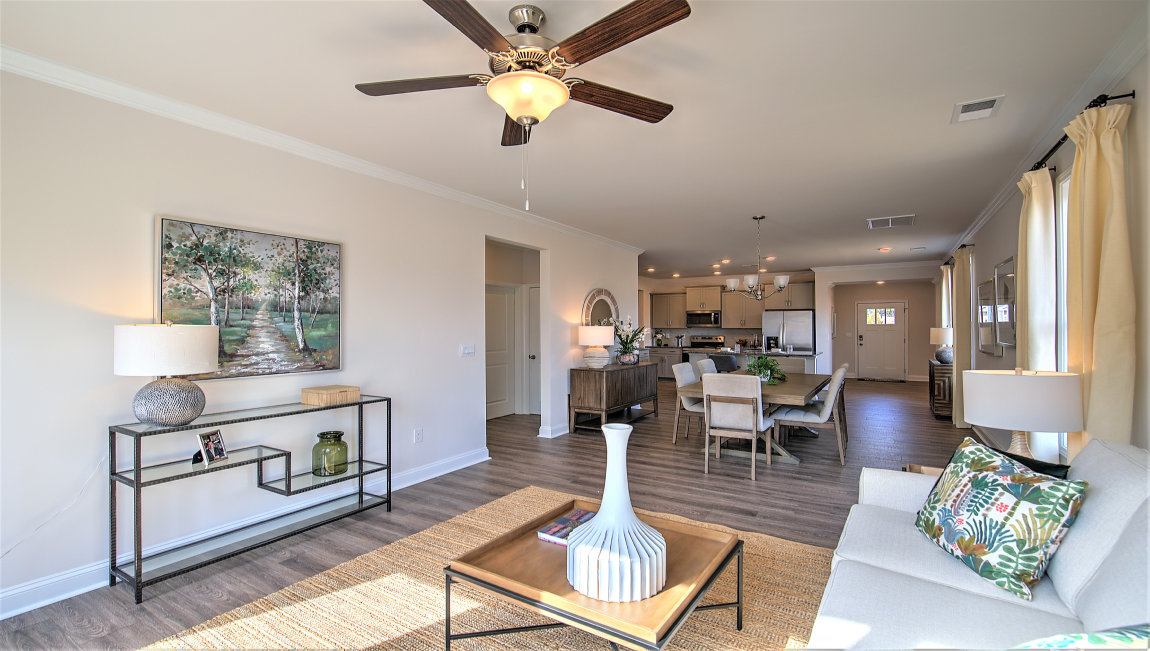 Living room beside kitchen with large windows and back door