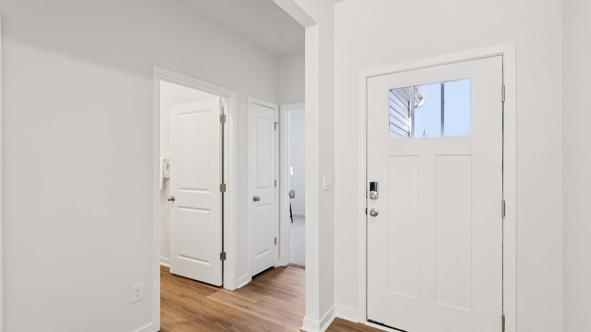 Front foyer with view of hallway and interior of front door