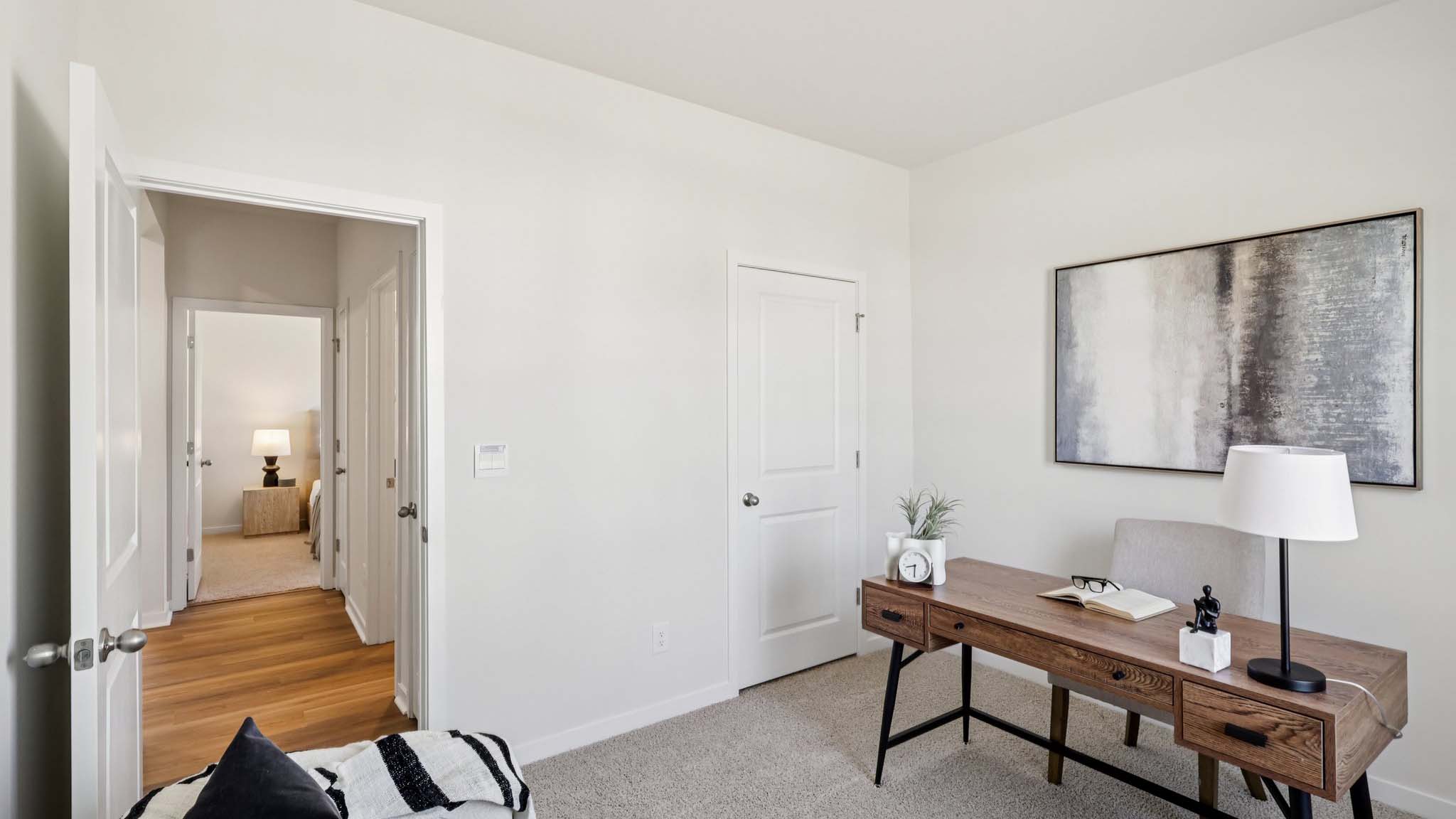 Carpeted bedroom with view of hallway and closet