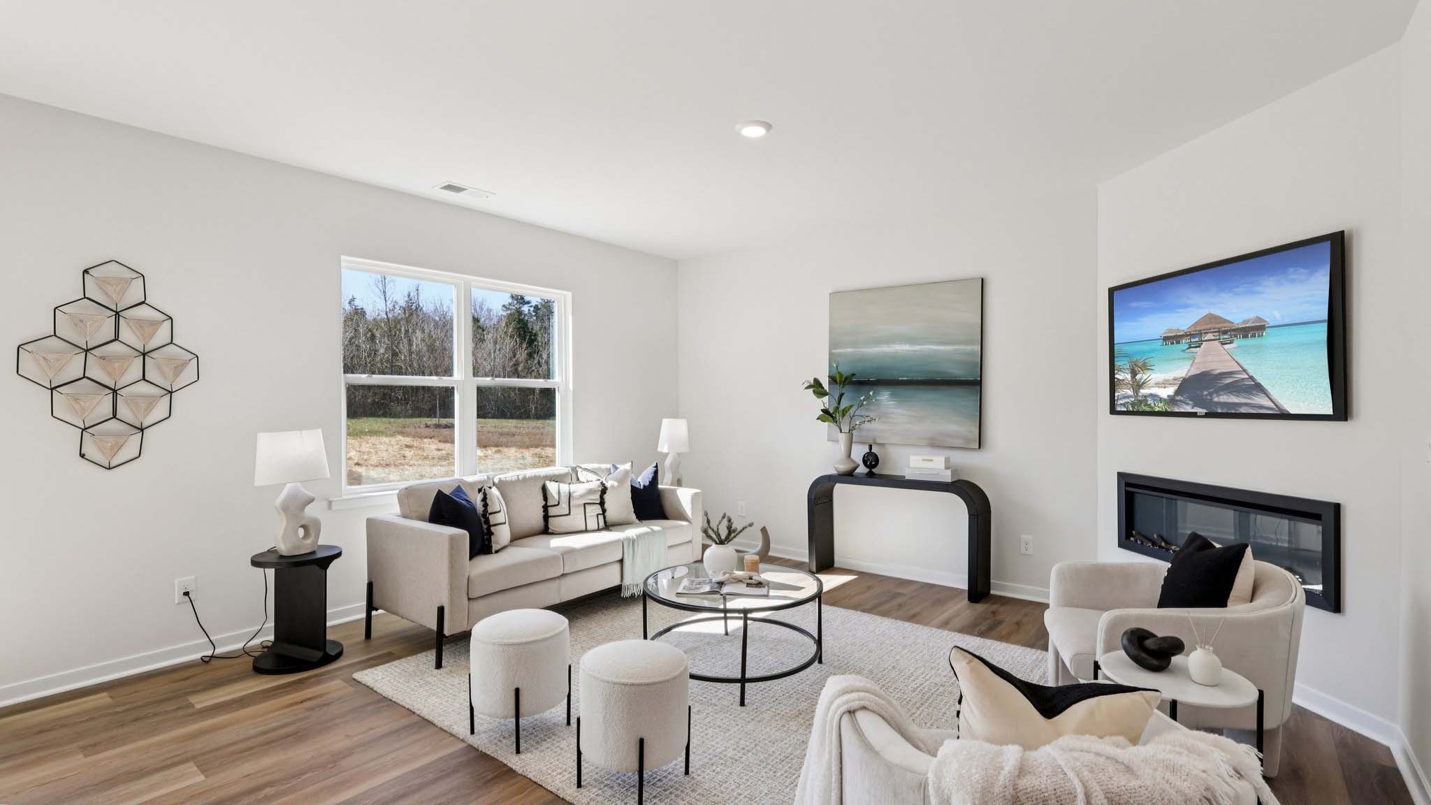 Open concept living area with large window and electric fireplace