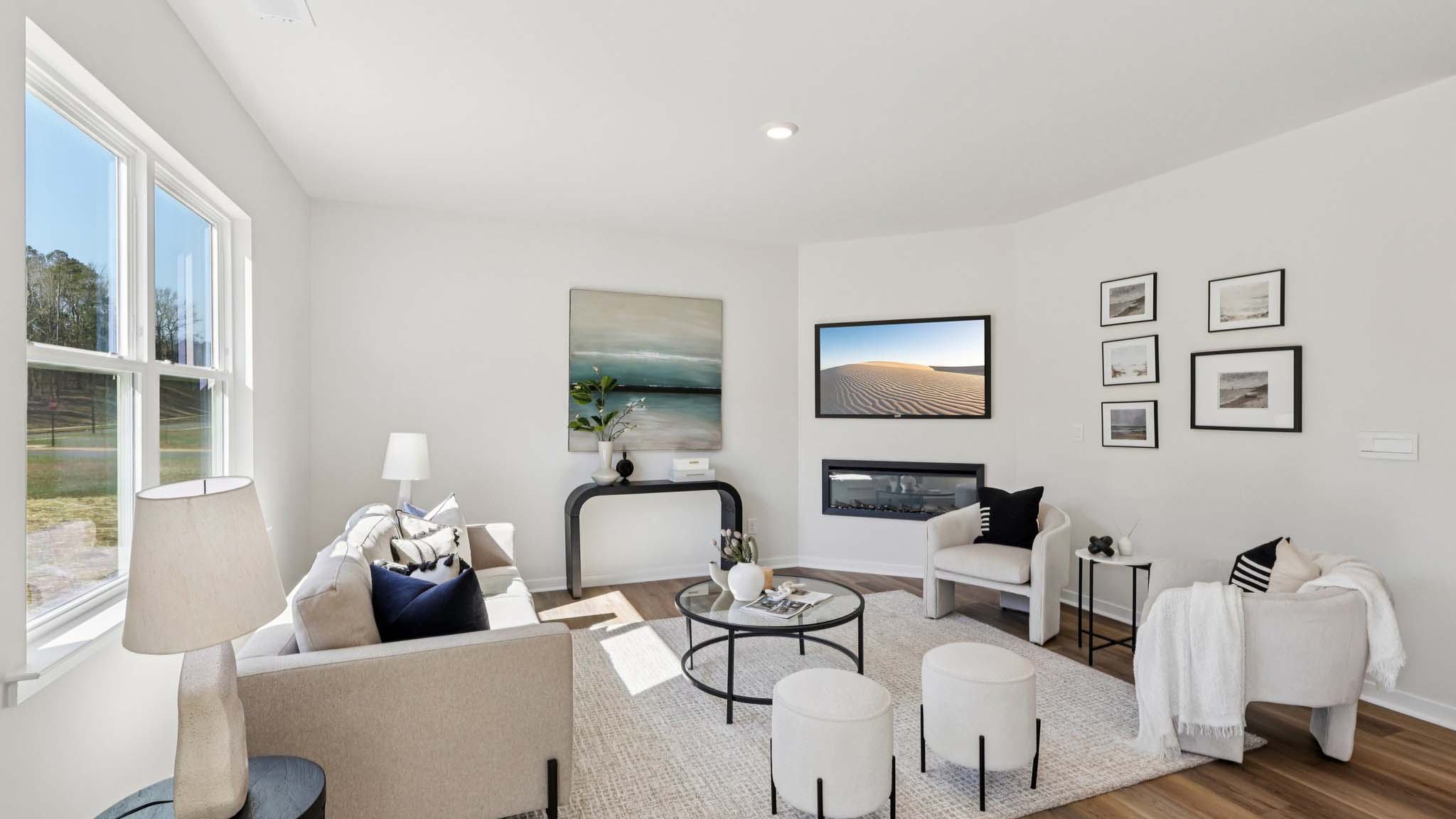 Open concept living area with large window and electric fireplace