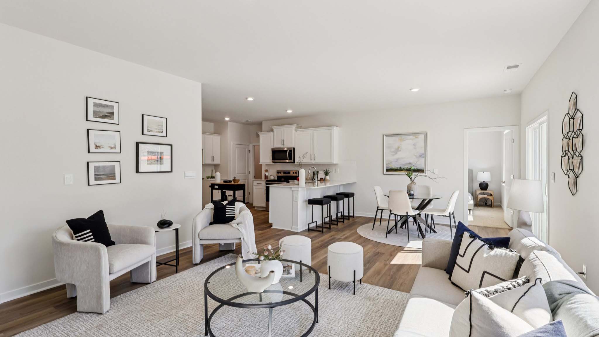 Open concept living area with large window and electric fireplace
