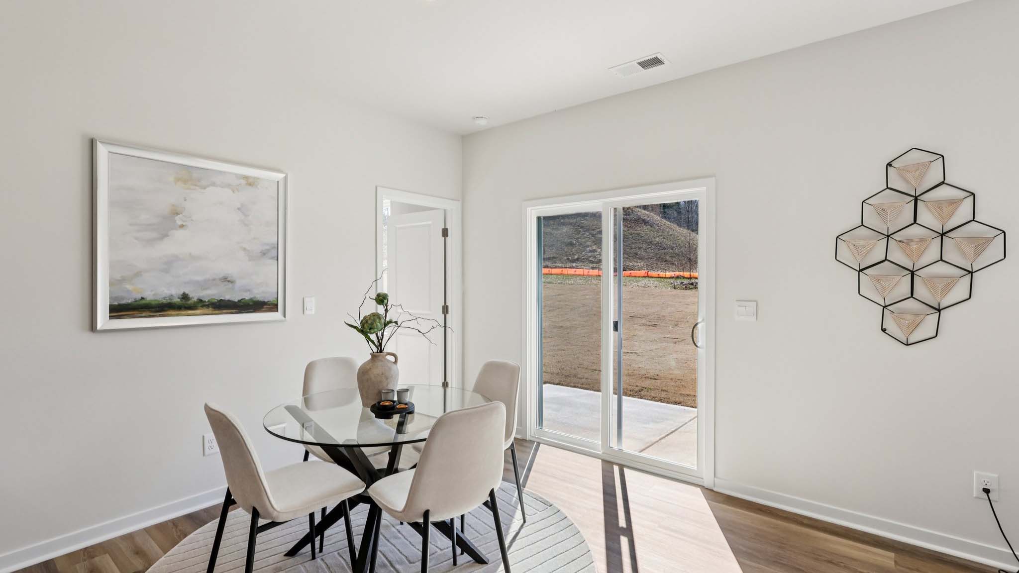 Open concept dining area with sliding glass door to patio
