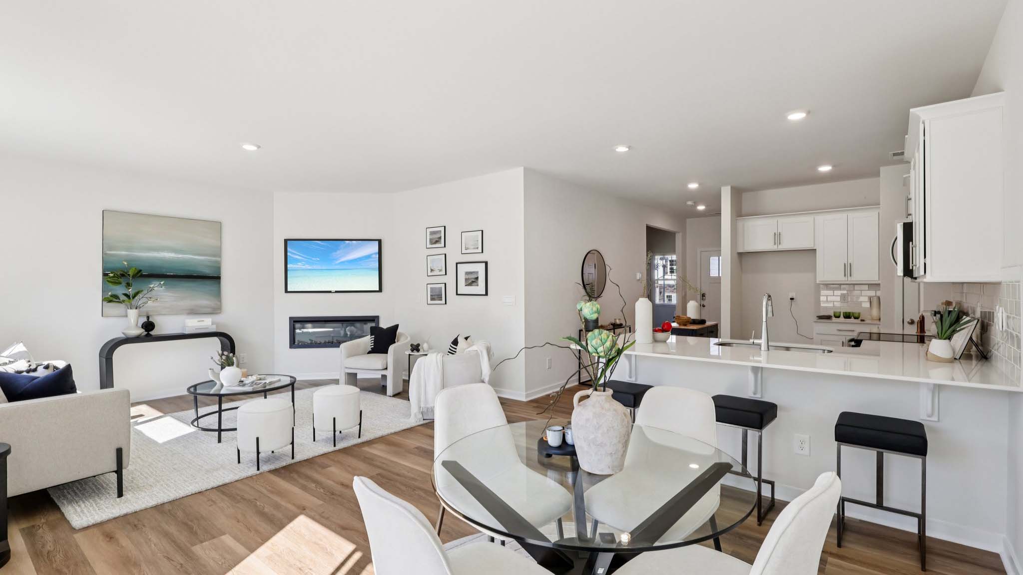 Open concept living area with large window and electric fireplace