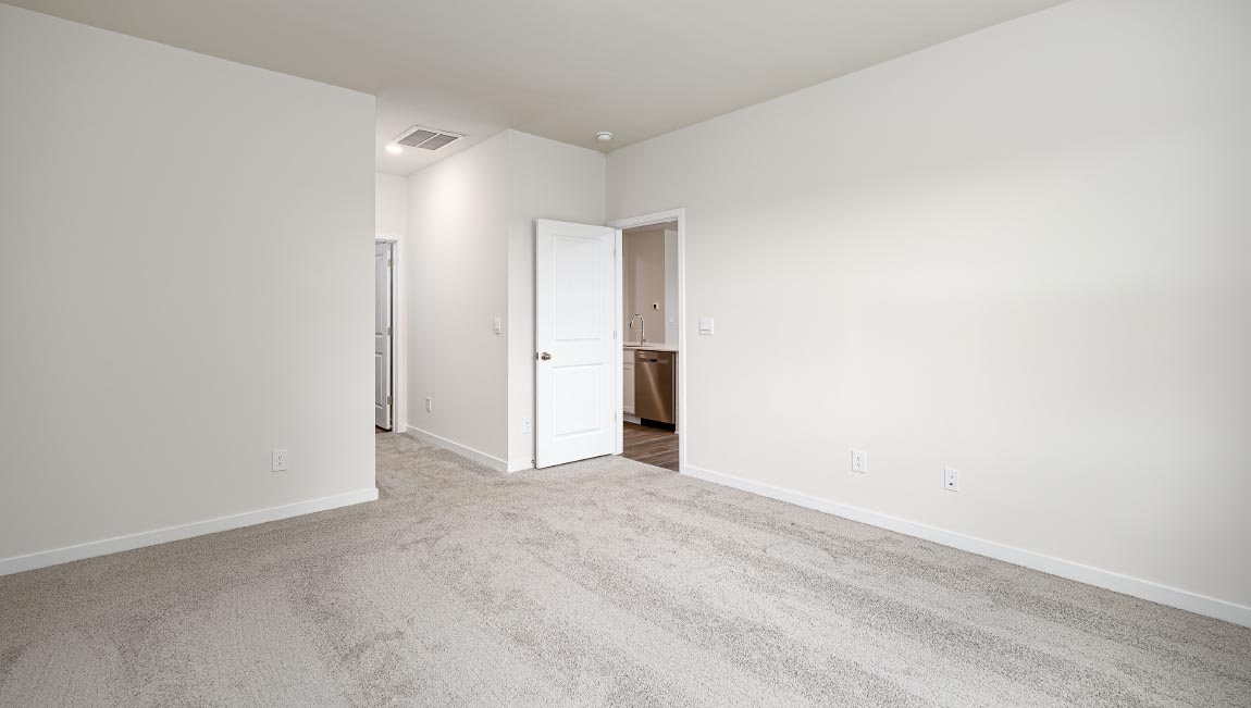 Carpeted bedroom with large windows