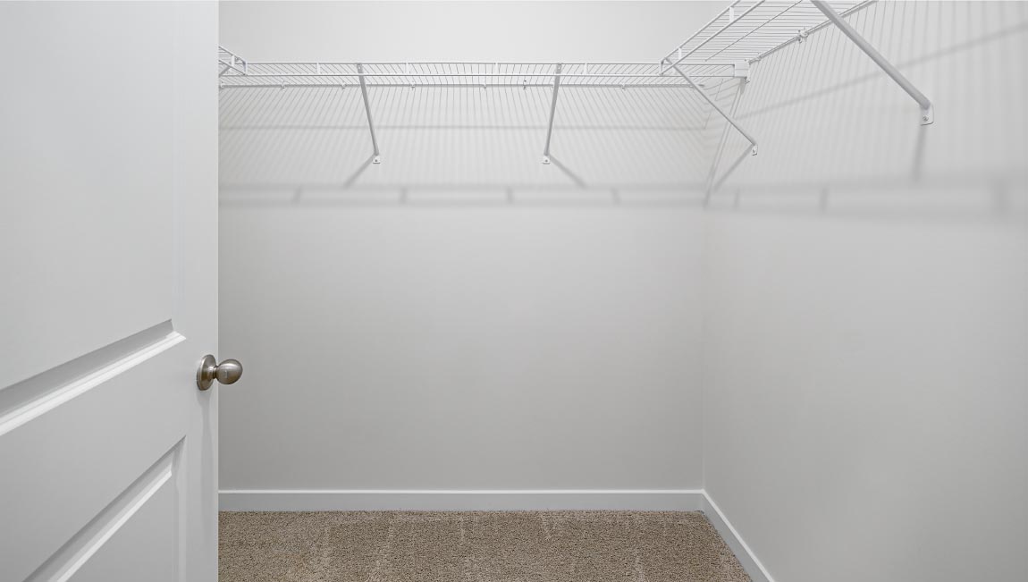 Primary walk in closet with shelving