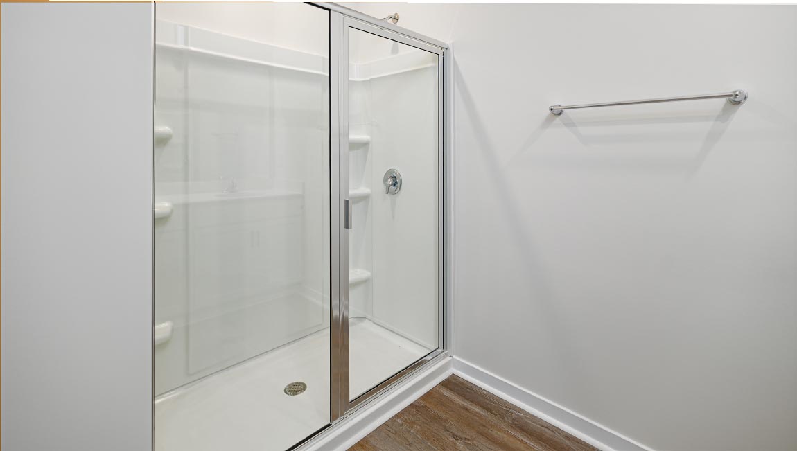 Primary bathroom with dual vanity and walk in shower with glass doors