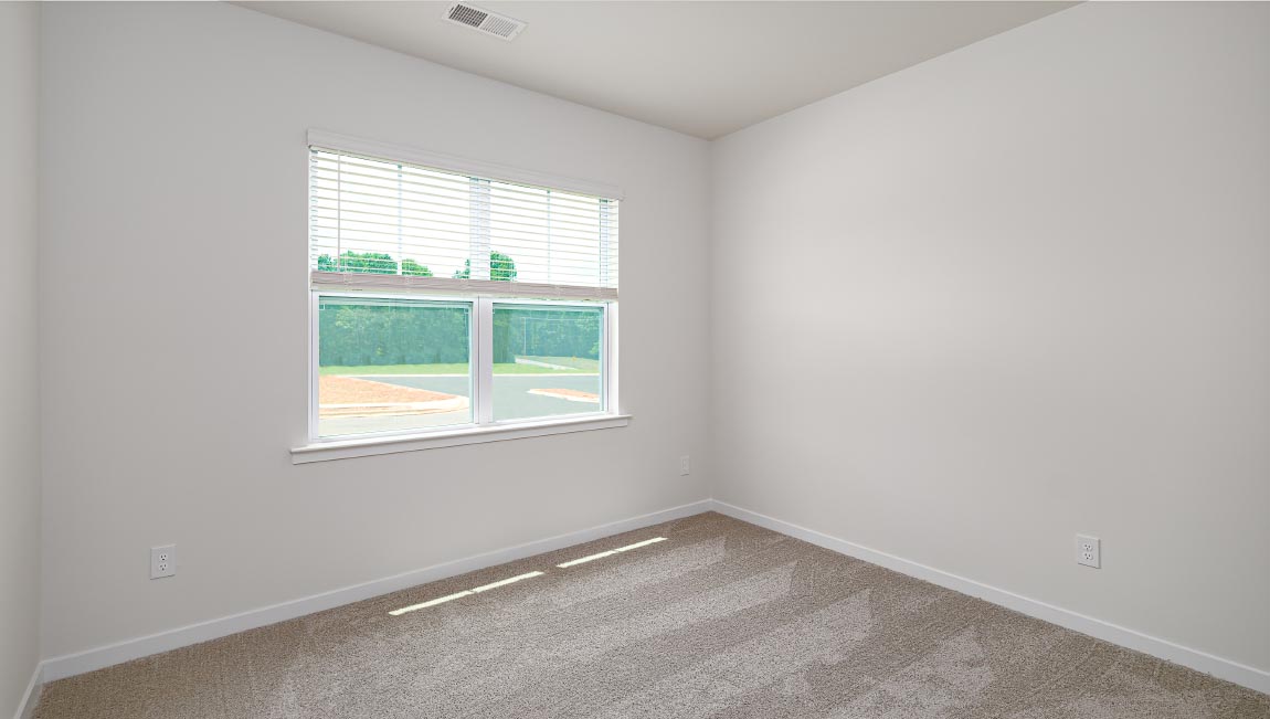 Carpeted bedroom with large windows