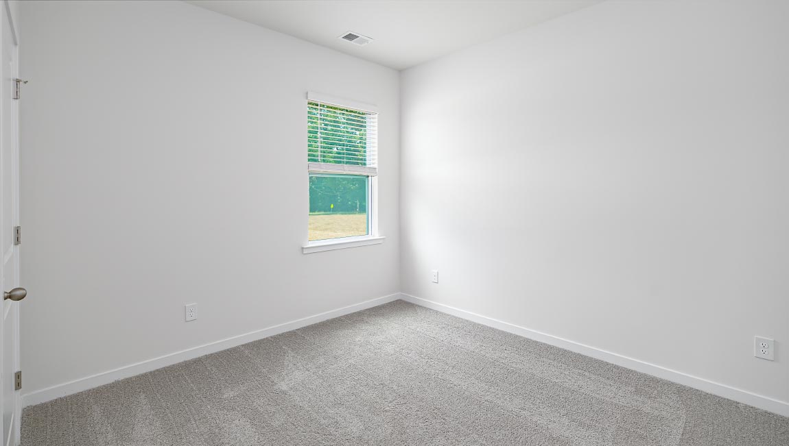 Carpeted bedroom with large windows