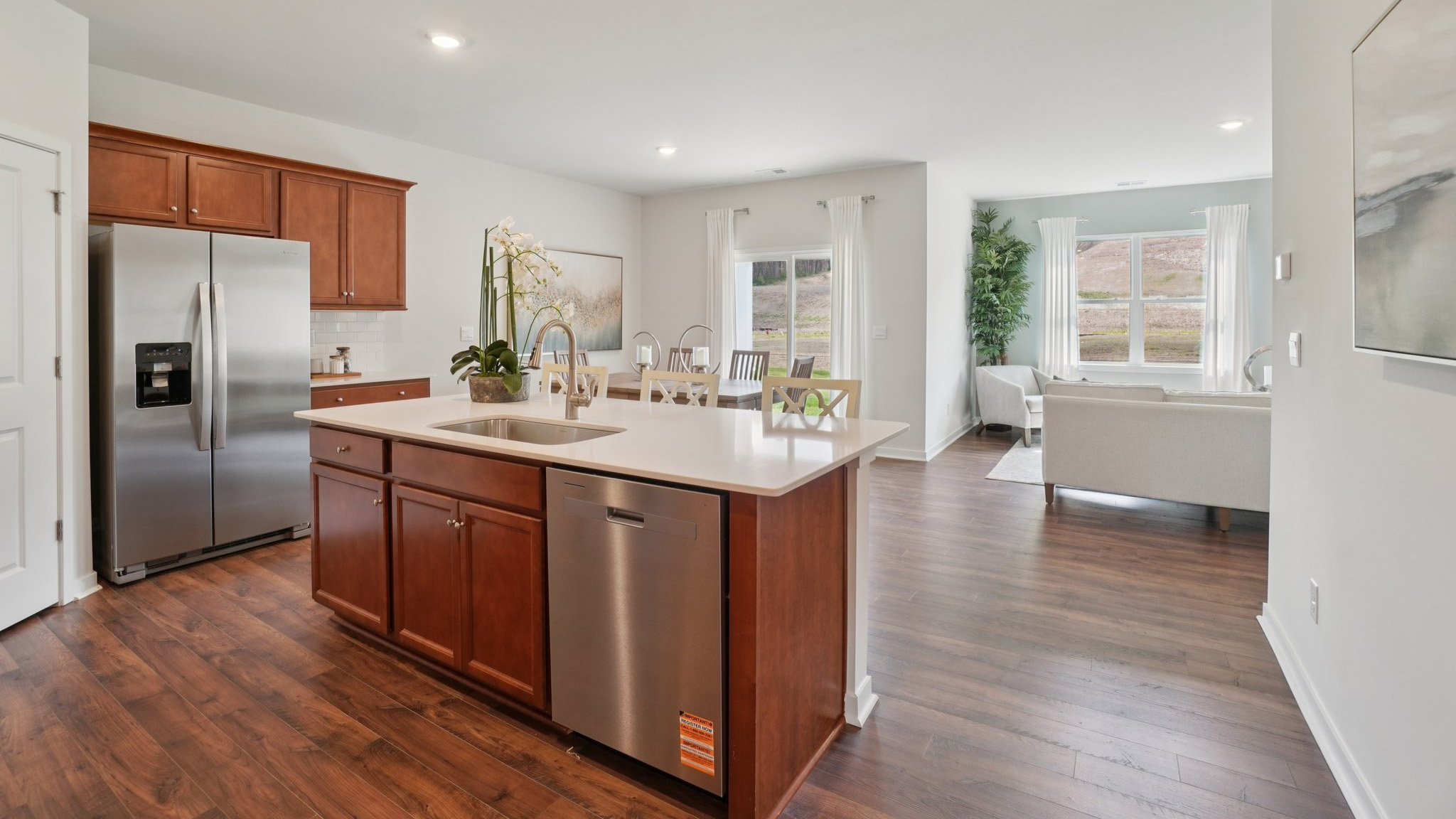 Open concept kitchen with stainless steel appliances and large island