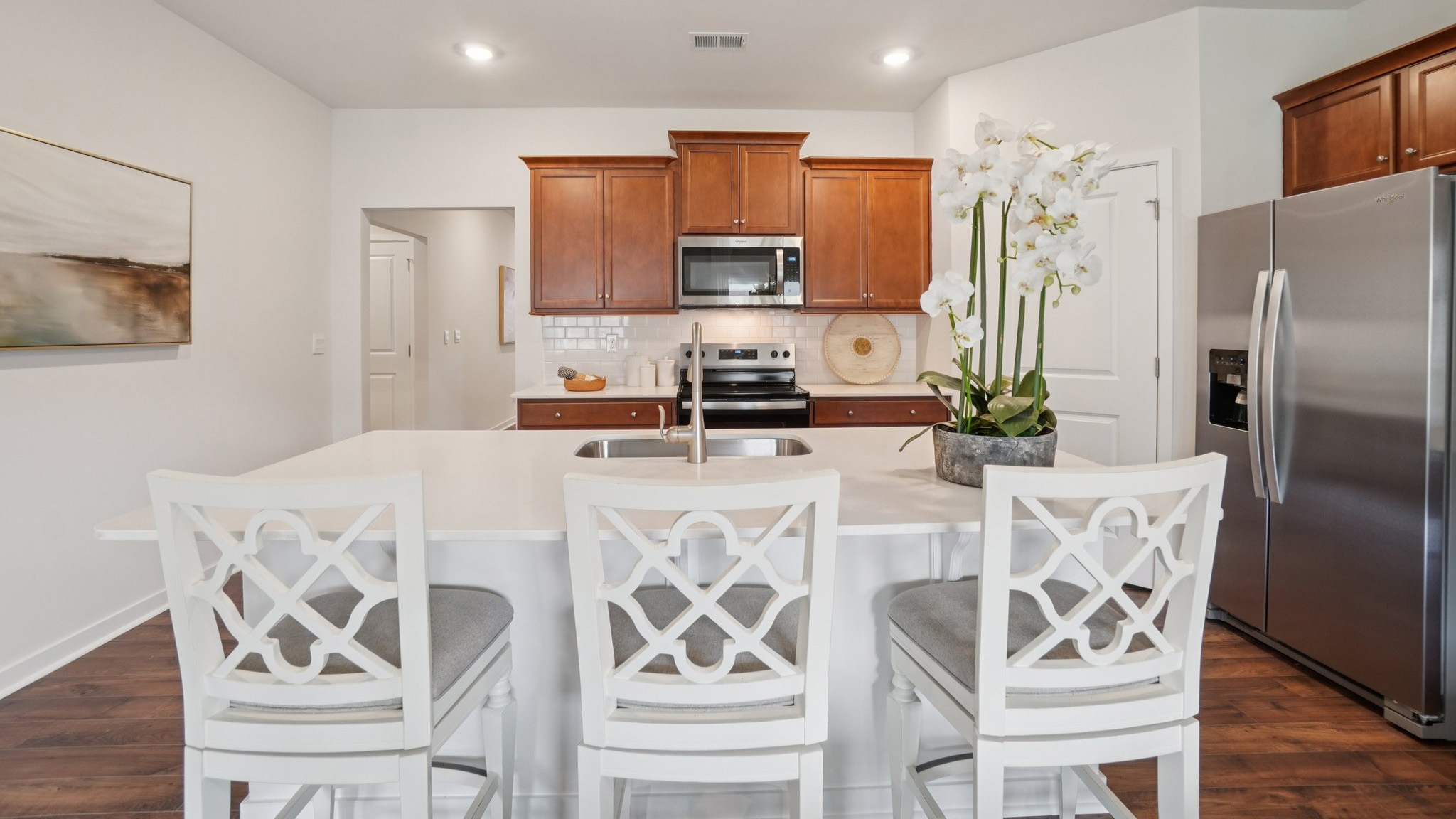 Open concept kitchen with stainless steel appliances and large island