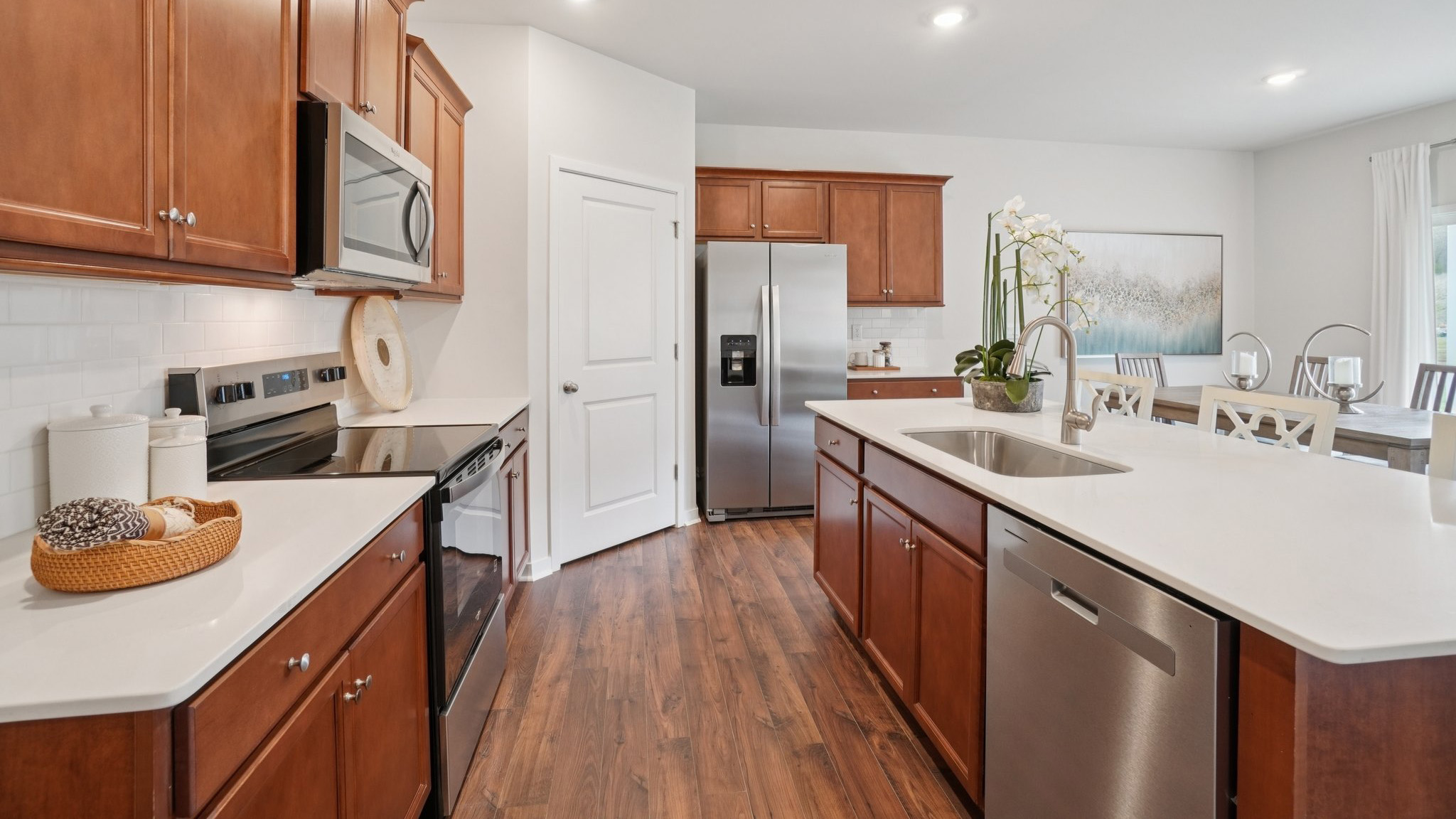 Open concept kitchen with stainless steel appliances and large island