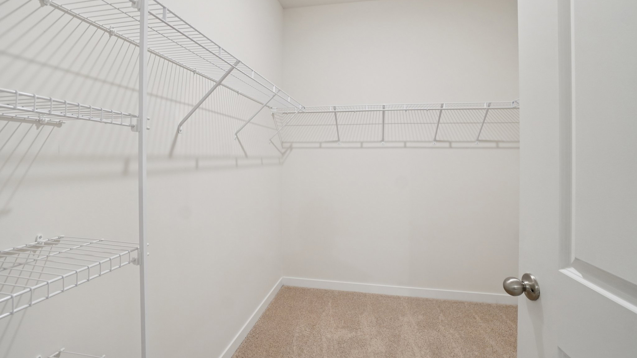 Primary walk in closet with shelving