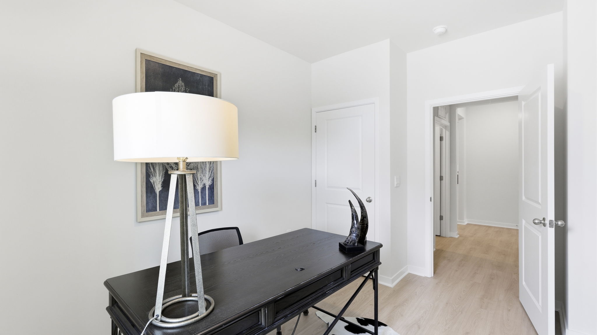 Bedroom set as a home office with view of hallway
