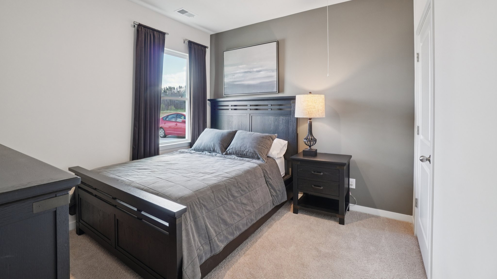 Carpeted bedroom with large window