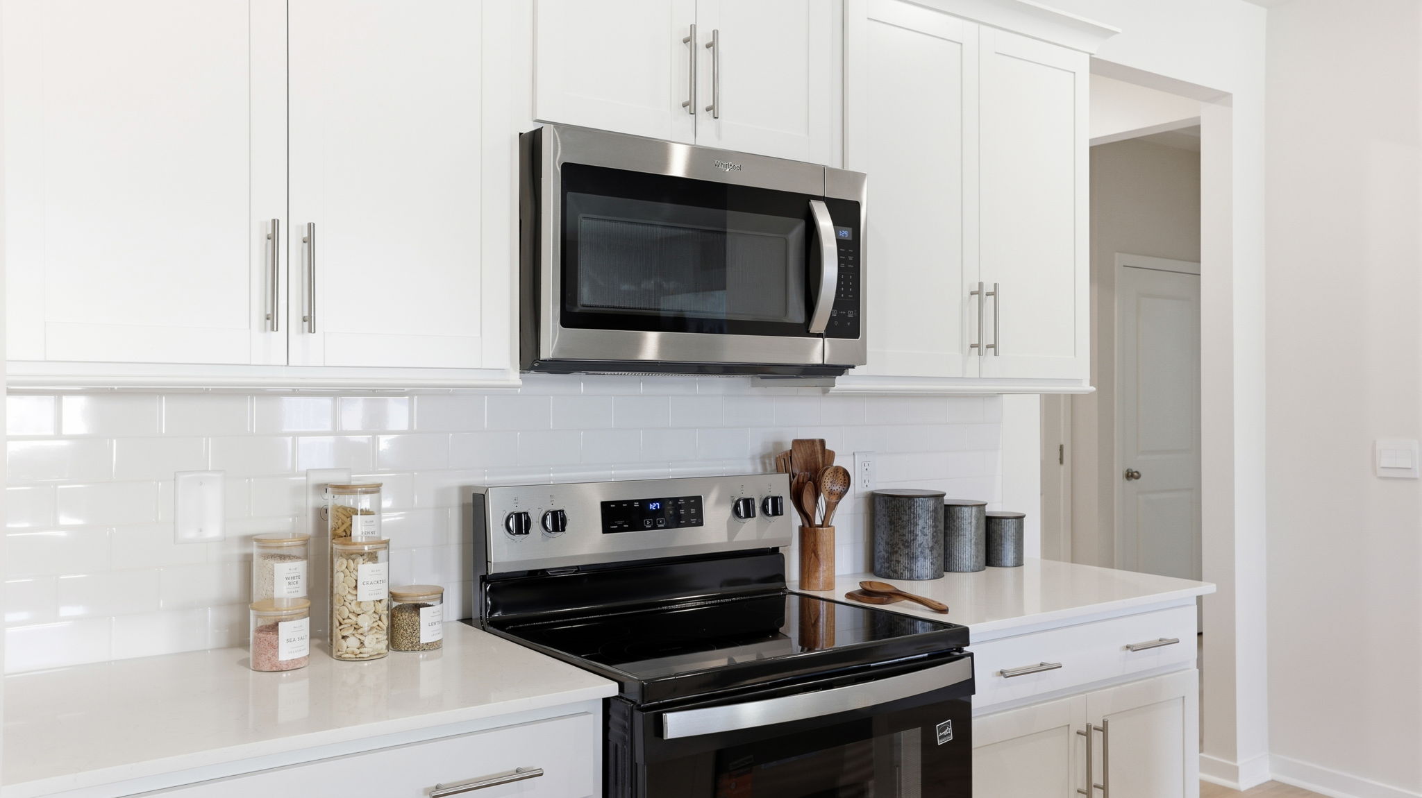 Open concept kitchen with stainless-steel appliances and large island