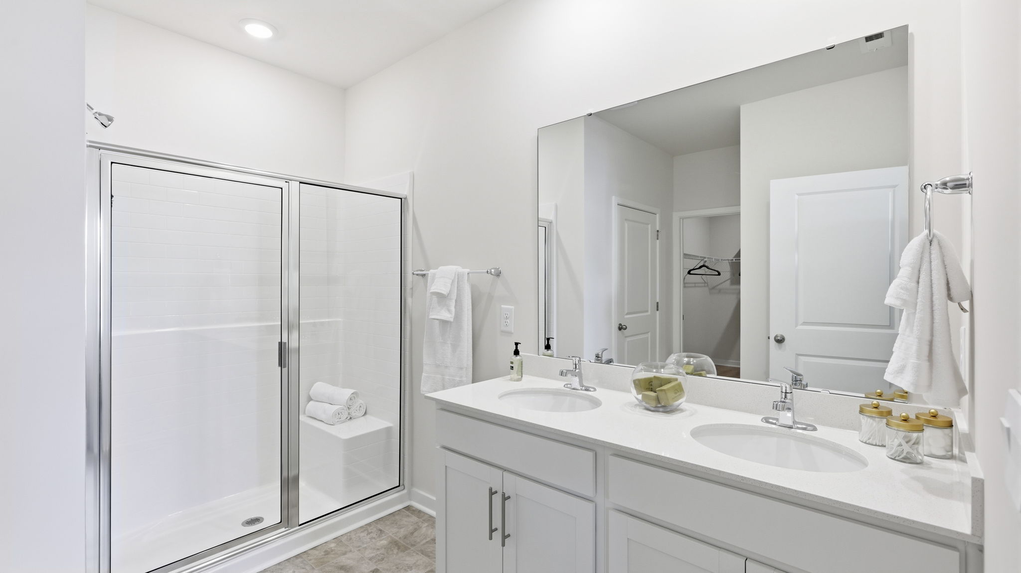 Primary bathroom with dual vanity and shower with glass doors