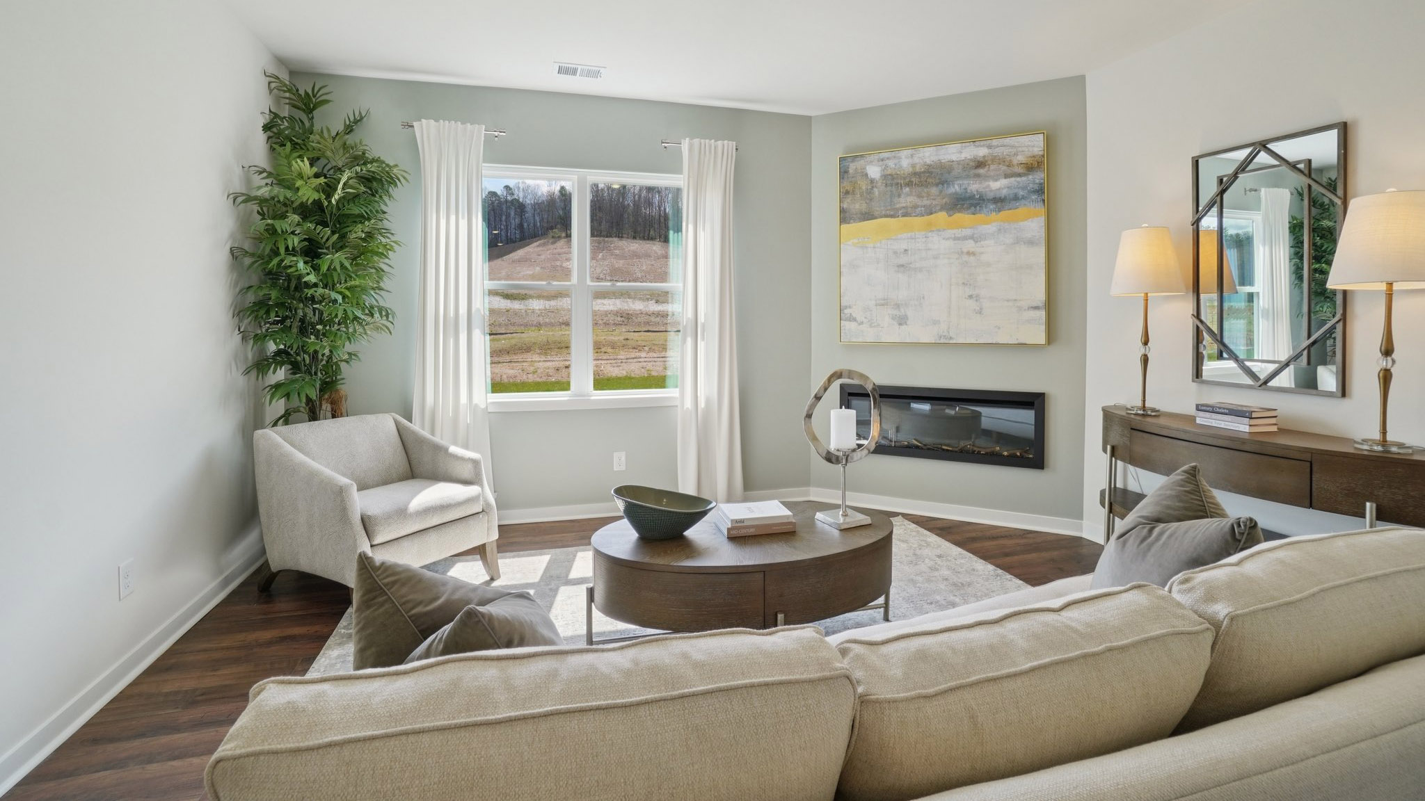 Open concept living room with large windows and electric fireplace