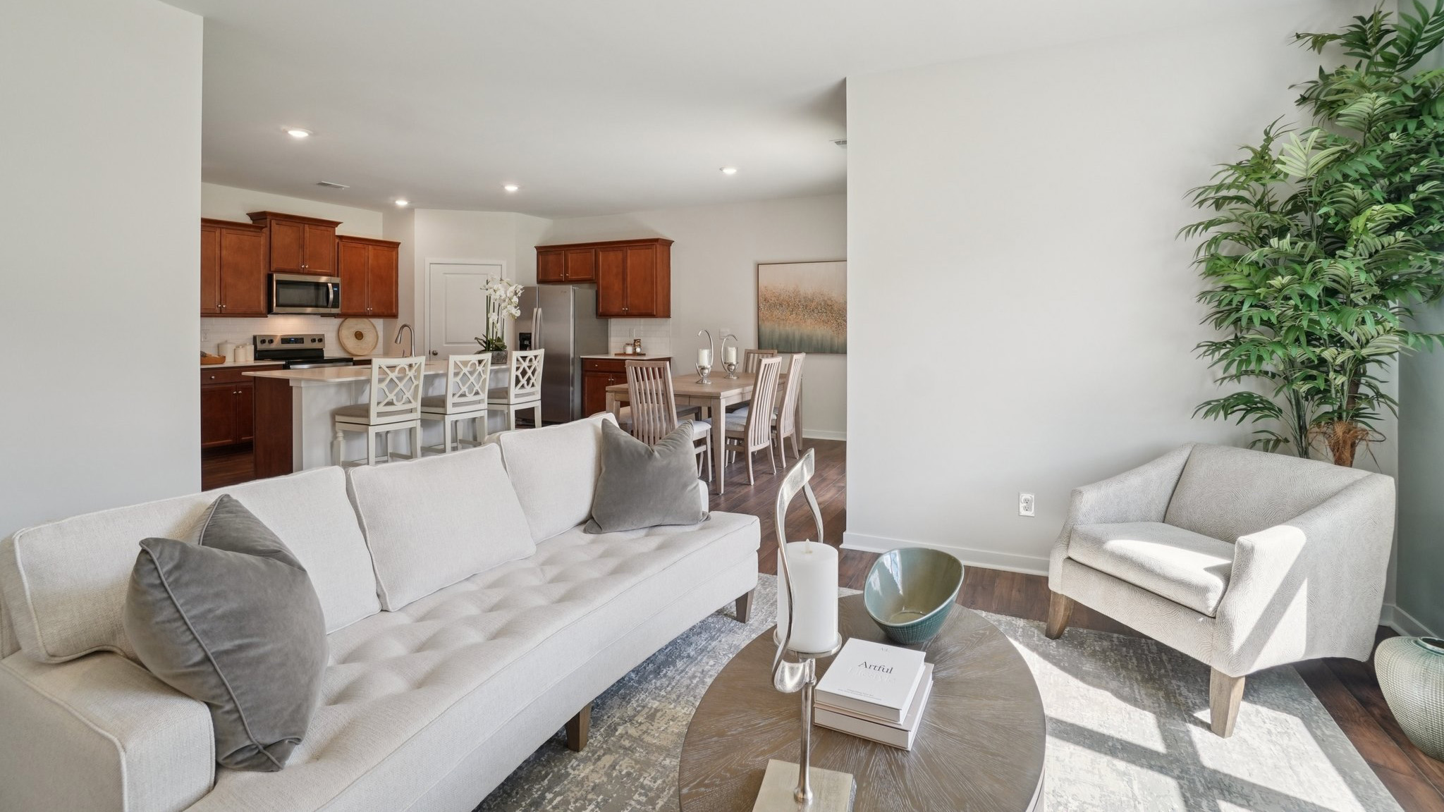 Open concept living room with large windows and electric fireplace