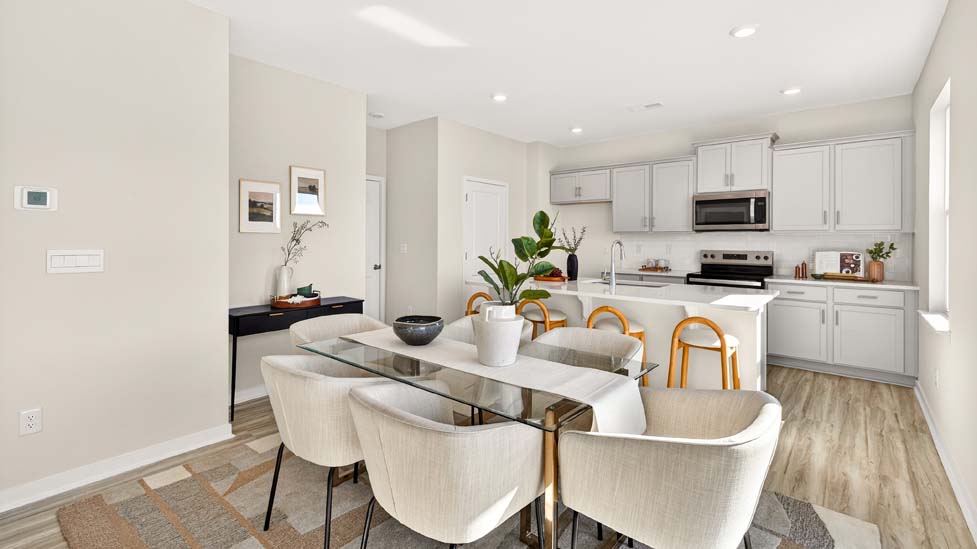 Open concept dining area with kitchen in the background