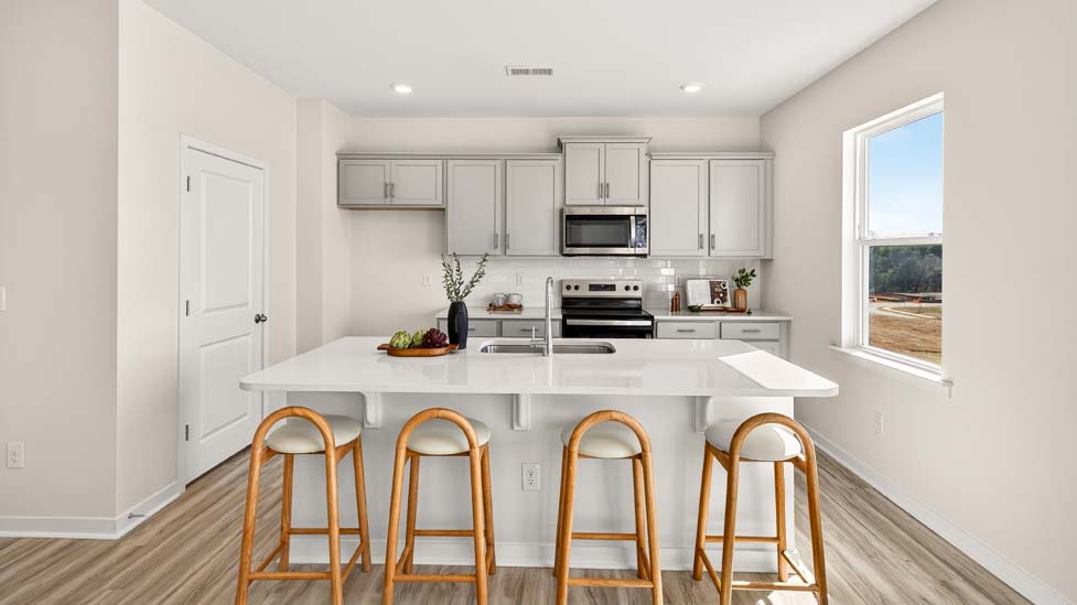 Open concept kitchen with large kitchen island and stainless steel appliances