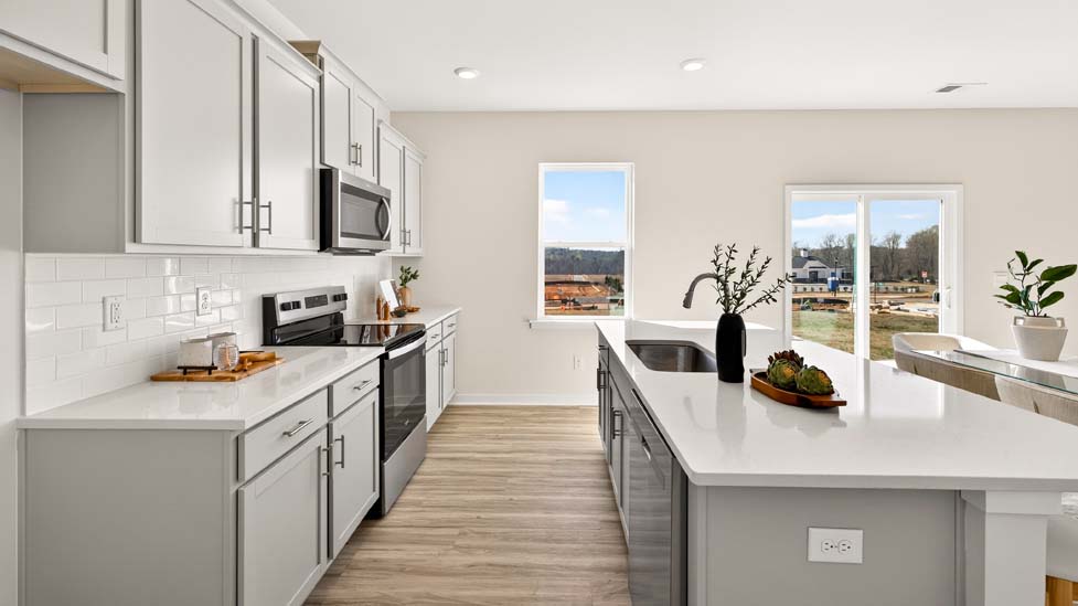 Open concept kitchen with large kitchen island and stainless steel appliances