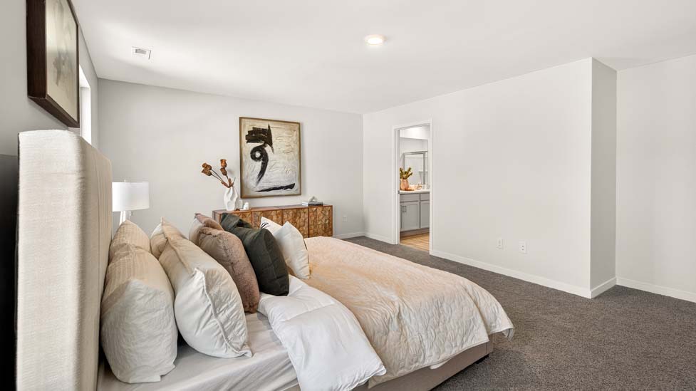 Carpeted primary bedroom with