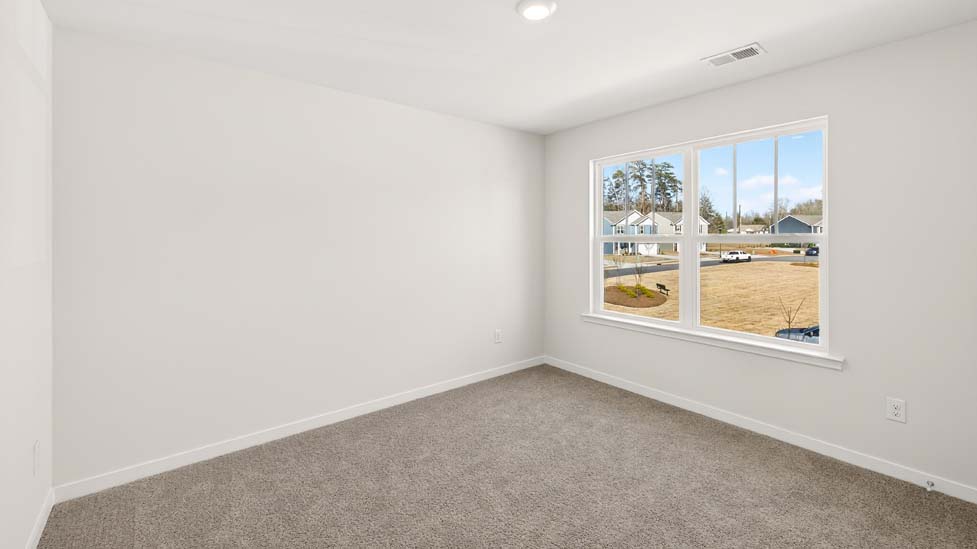 Carpeted bedroom with large windows