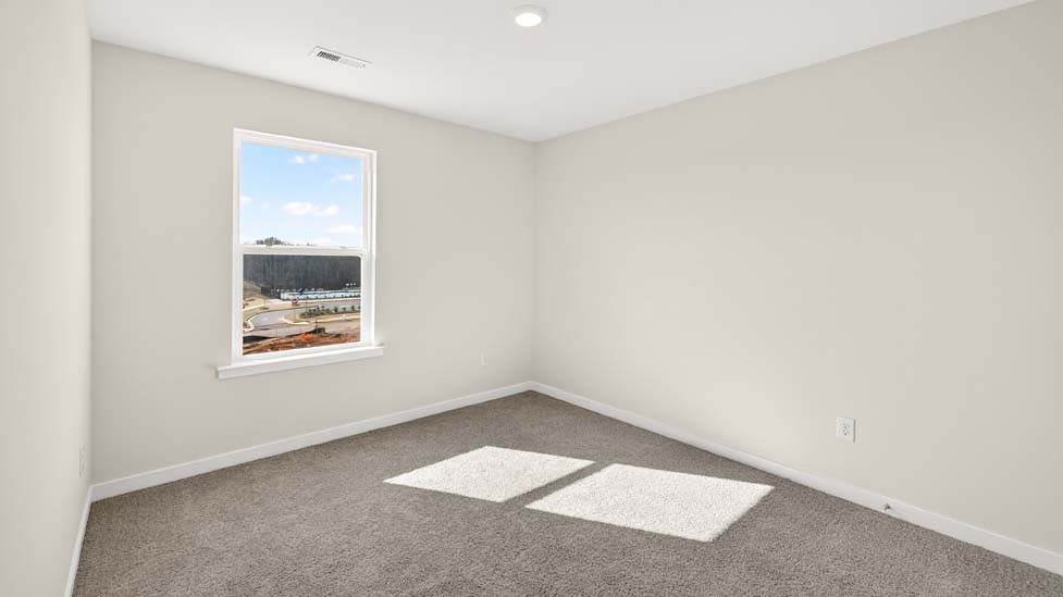 Carpeted bedroom with large windows