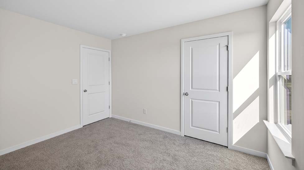 Carpeted bedroom with closet