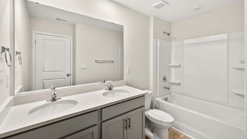 Bathroom with dual vanity and bathtub