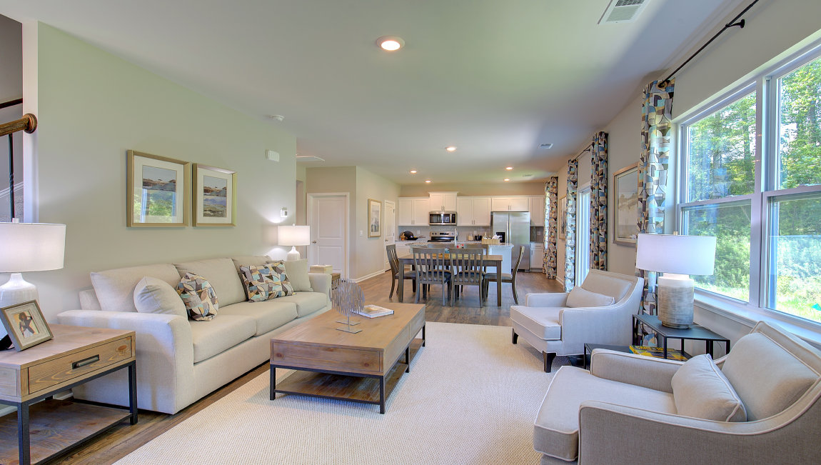 Open living area with electric fireplace and large windows