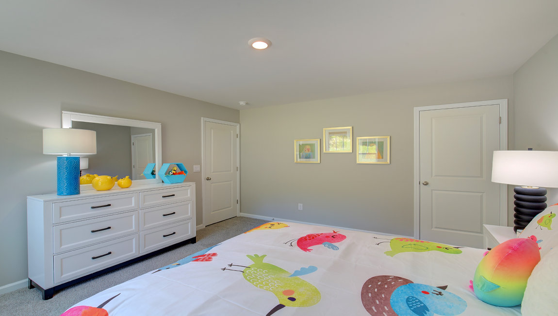 Carpeted bedroom with large windows