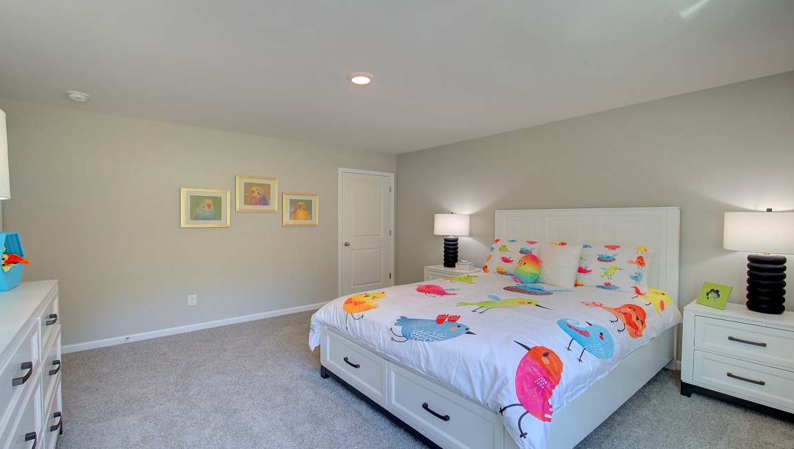 Carpeted bedroom with large windows