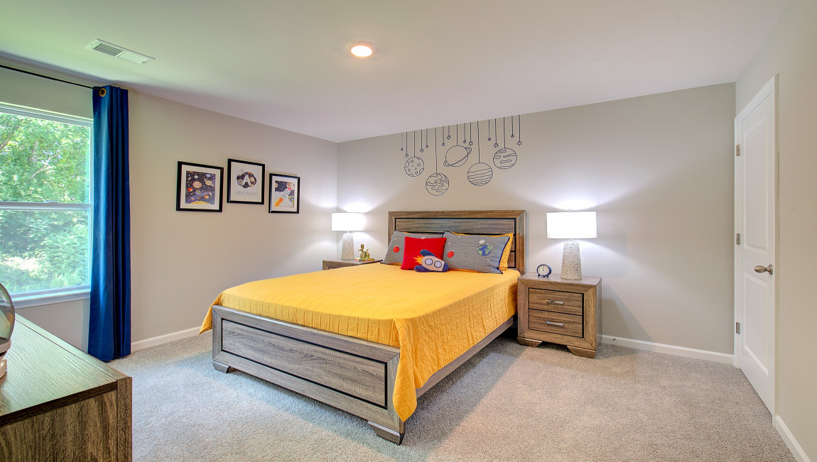 Carpeted bedroom with large windows
