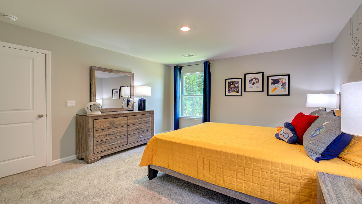 Carpeted bedroom with large windows