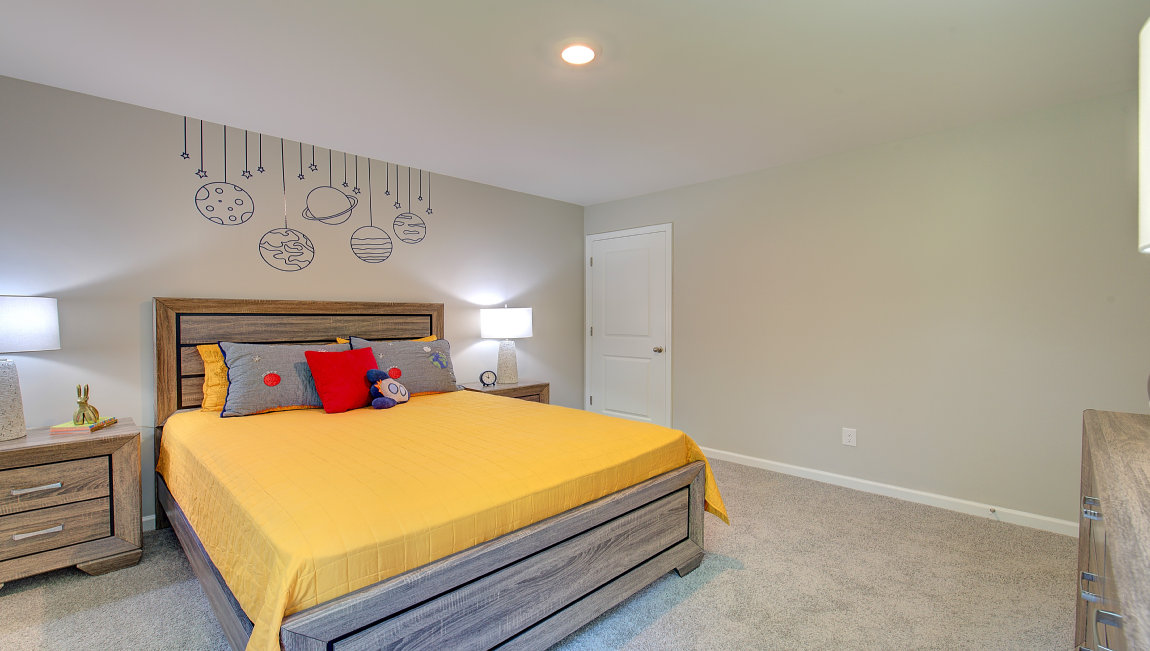Carpeted bedroom with large windows