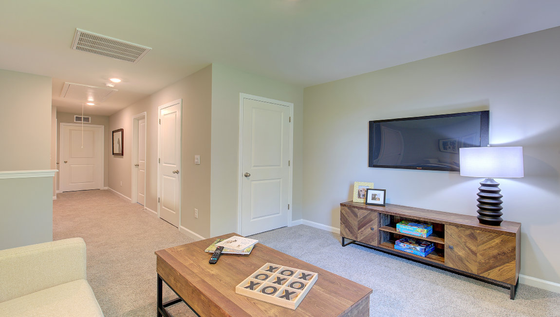 Open carpeted loft area with large window