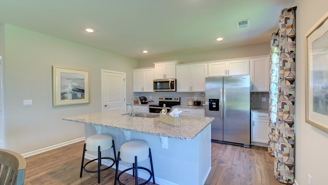 Open concept kitchen with large island and stainless steel appliances