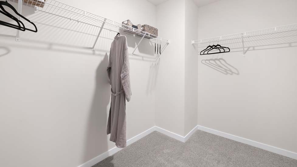 Primary walk in closet with shelving