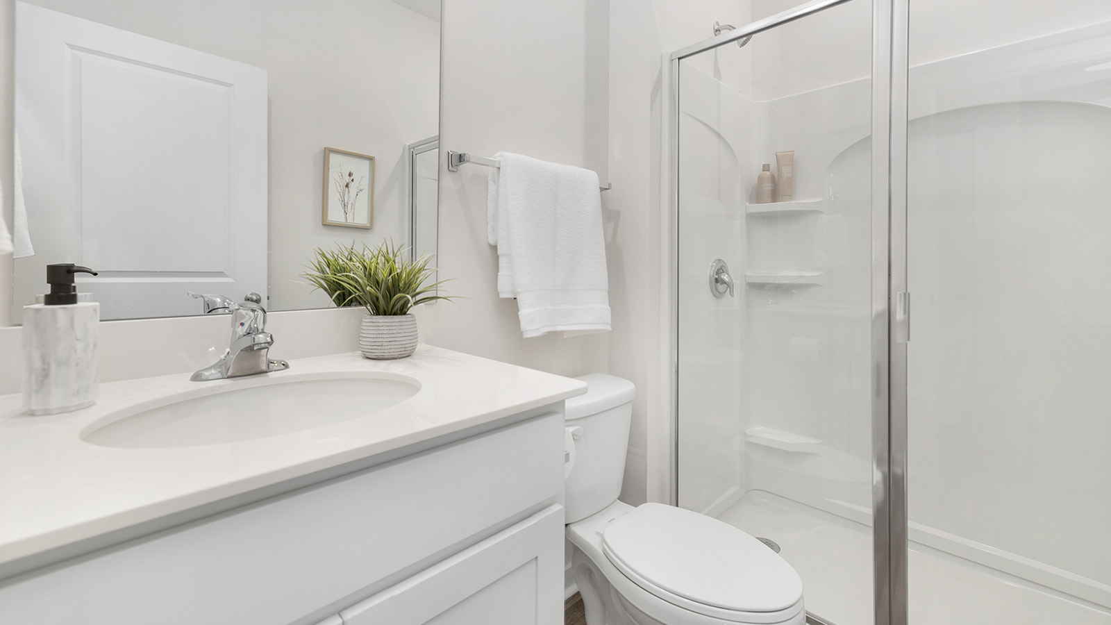 Bathroom with single vanity and walk in shower with glass doors