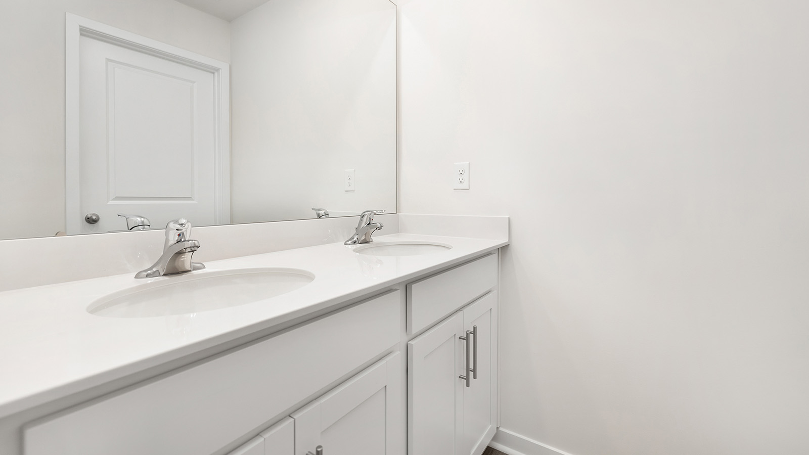 Bathroom with dual vanity and mirror