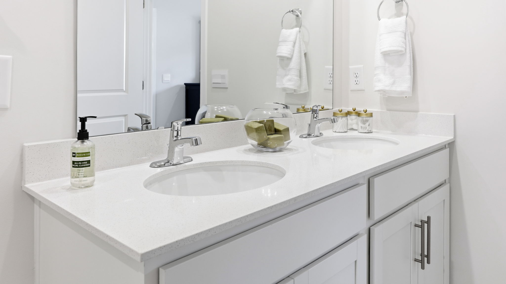 Primary bathroom with dual vanity and large mirror
