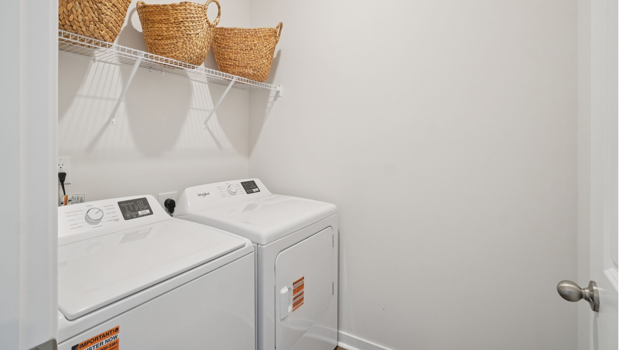 Laundry room with washer, dryer and shelving