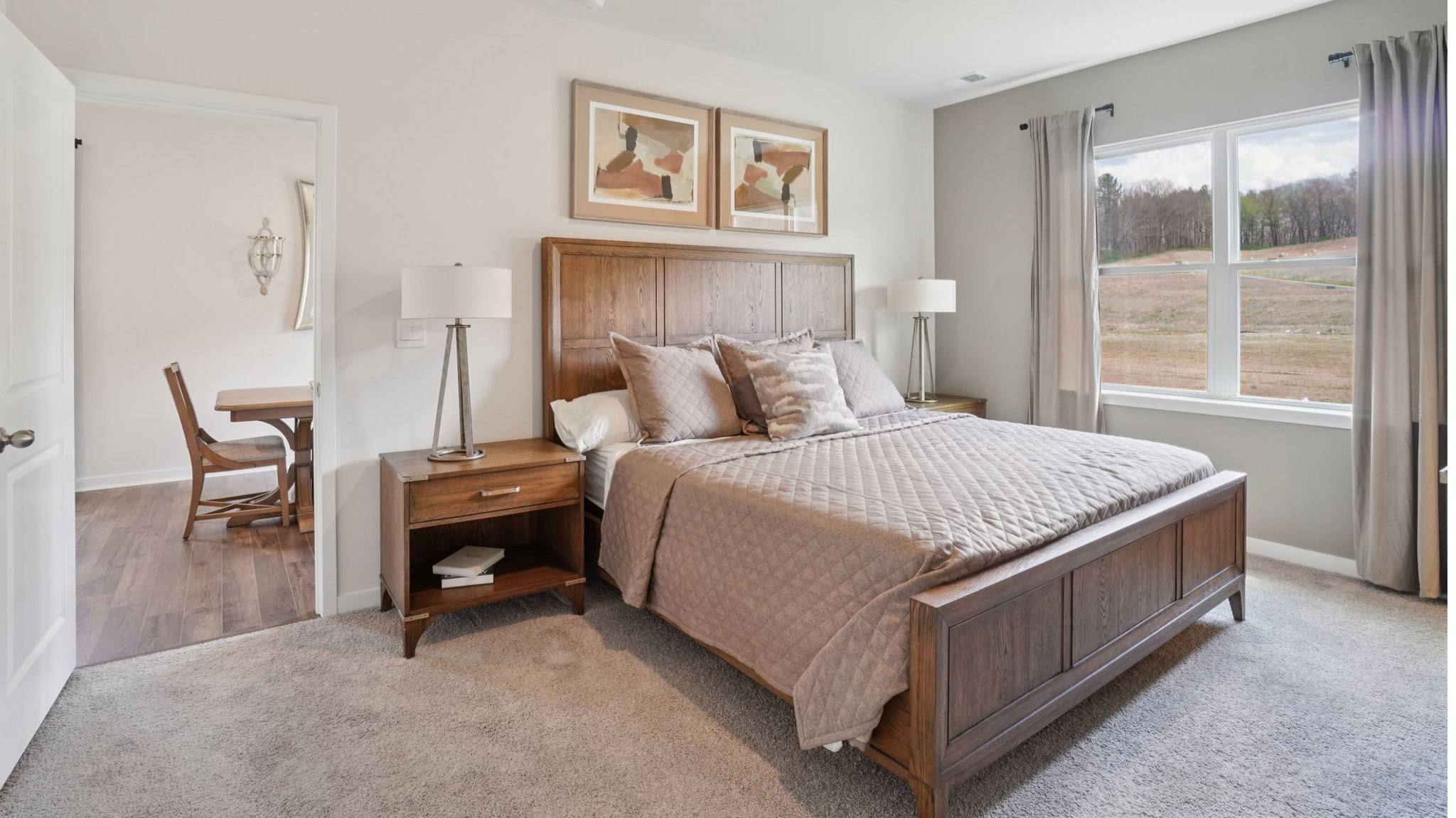 Carpeted primary bedroom with large windows