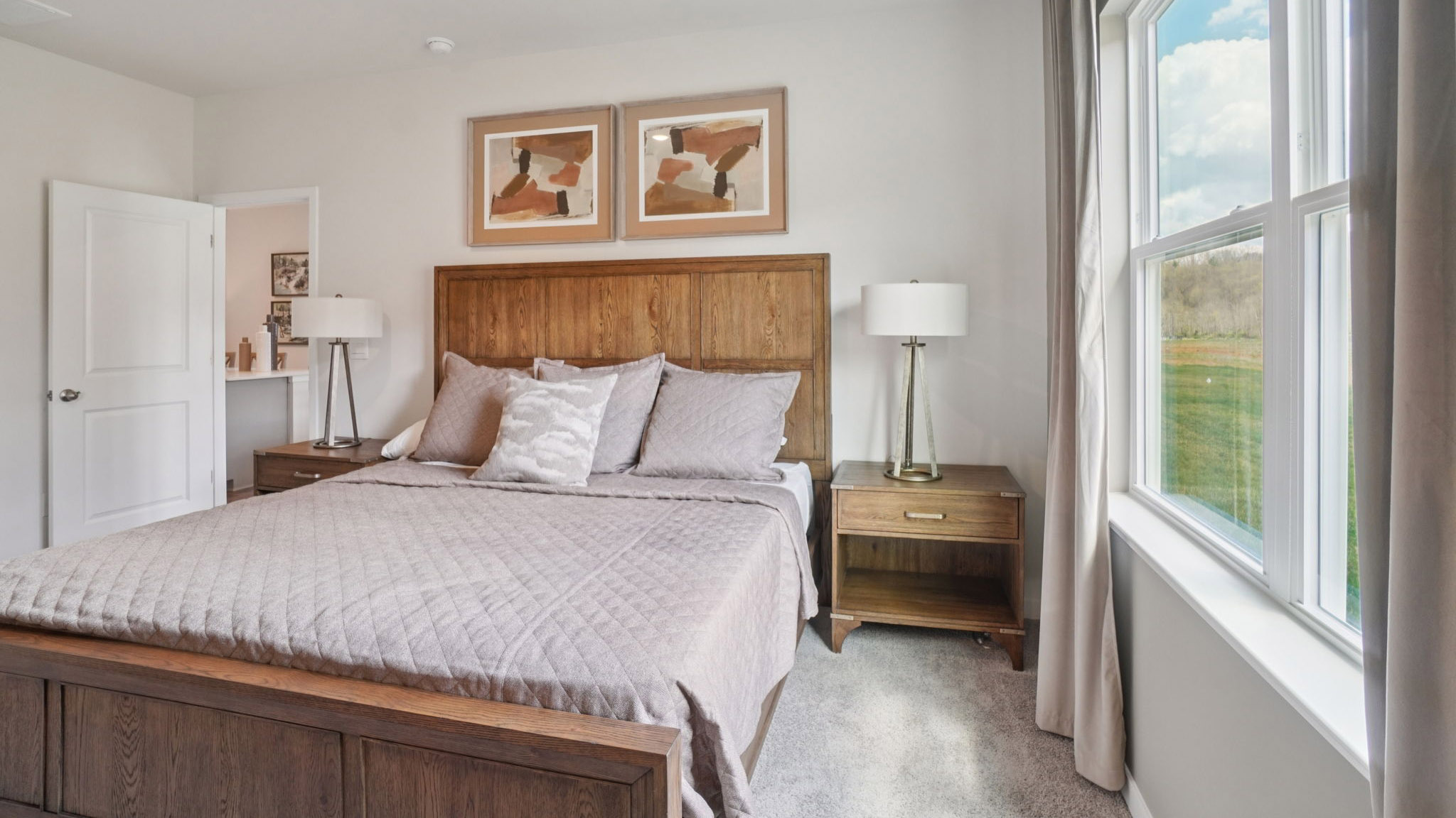Carpeted primary bedroom with large windows