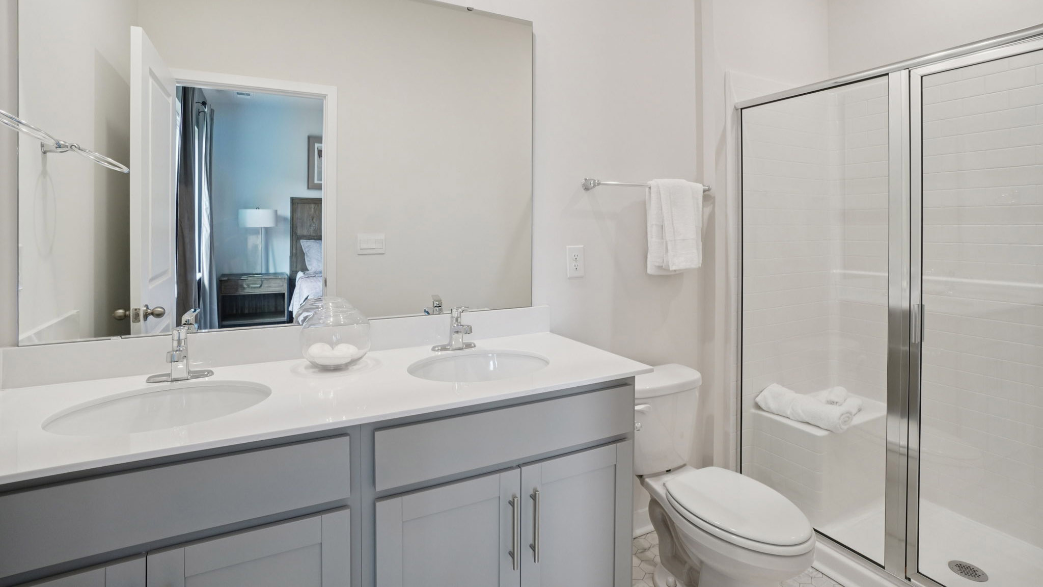 Primary bathroom with dual vanity and walk in shower