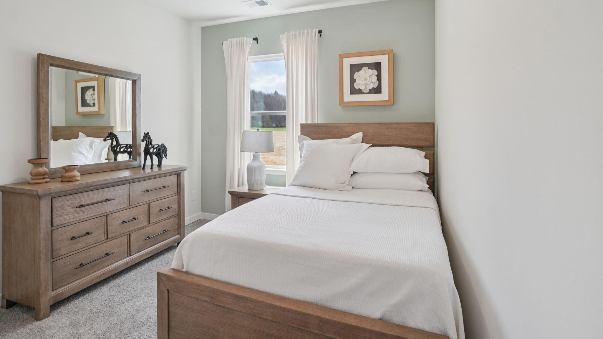 Carpeted bedroom with large window