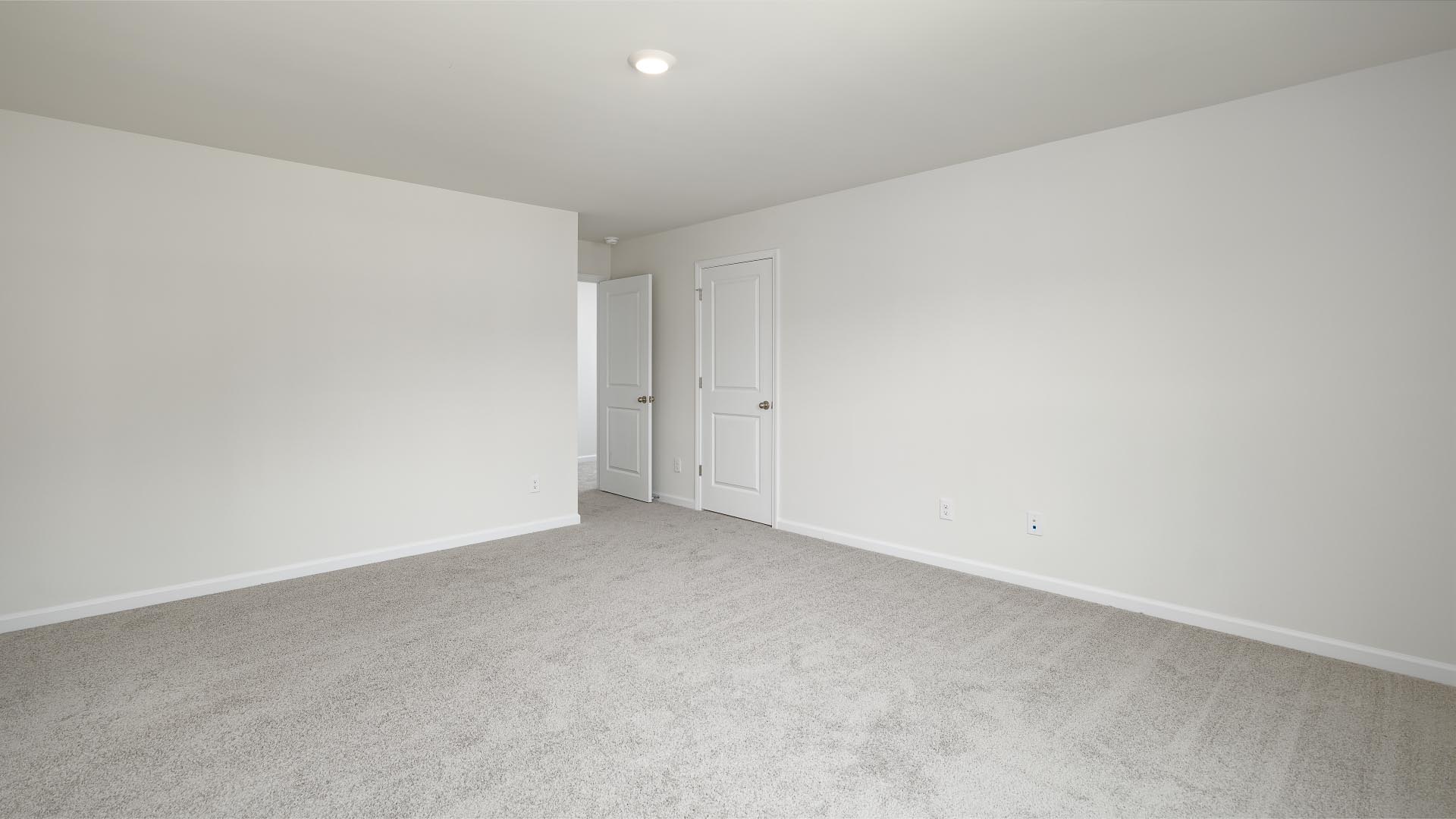 Carpeted upstairs loft with hallways